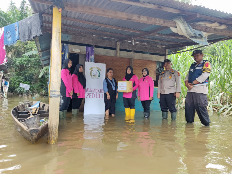 Susuri Banjir, Kapolsek Lirik dan Ketua Bhayangkari Bawa Pesan Pemilu Damai dan Bansos